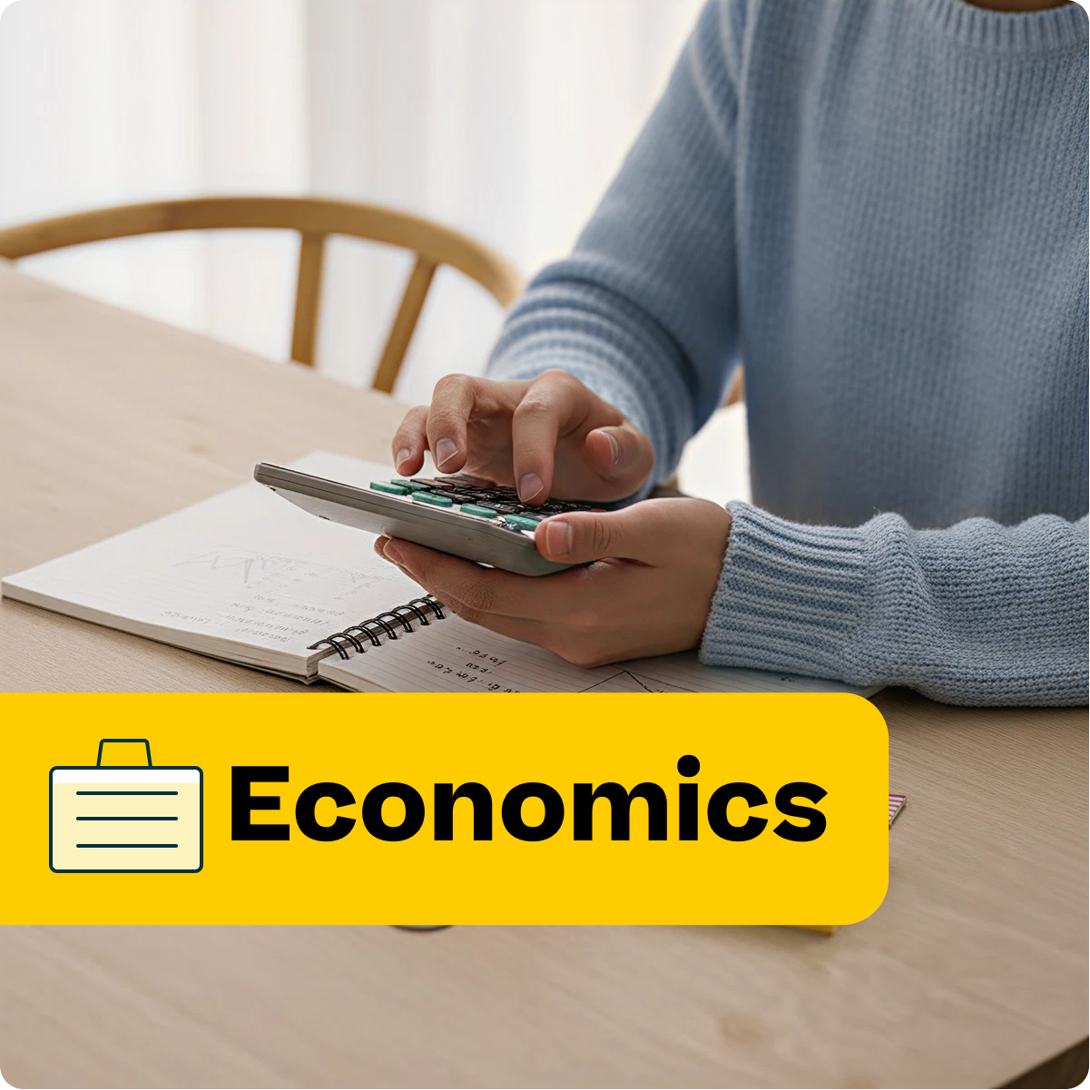 Person using a calculator with an economics label on a table