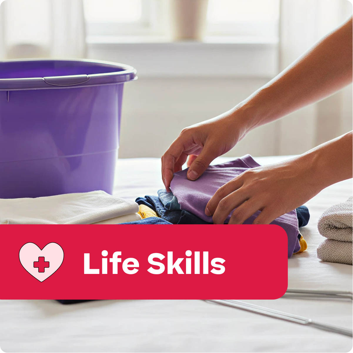 Person folding clothes with a purple bucket and 'Life Skills' label in the foreground.