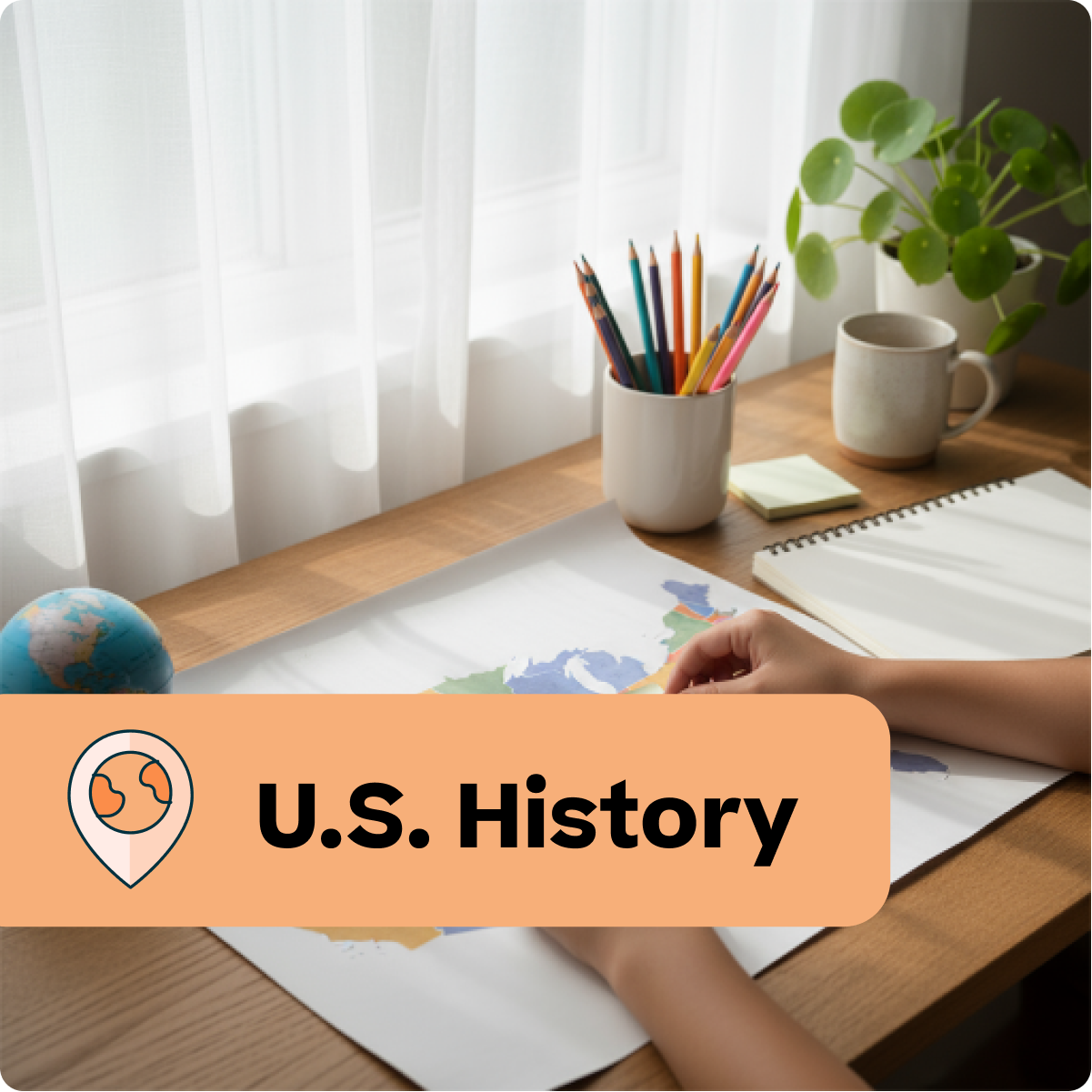 Person studying U.S. History at a desk with a world map, pencils, and a mug.