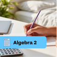 Hand holding a pen with 'Algebra 2' text and calculator on a desk.