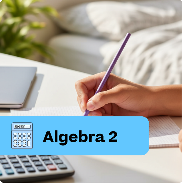 Hand holding a pen with 'Algebra 2' text and calculator on a desk.