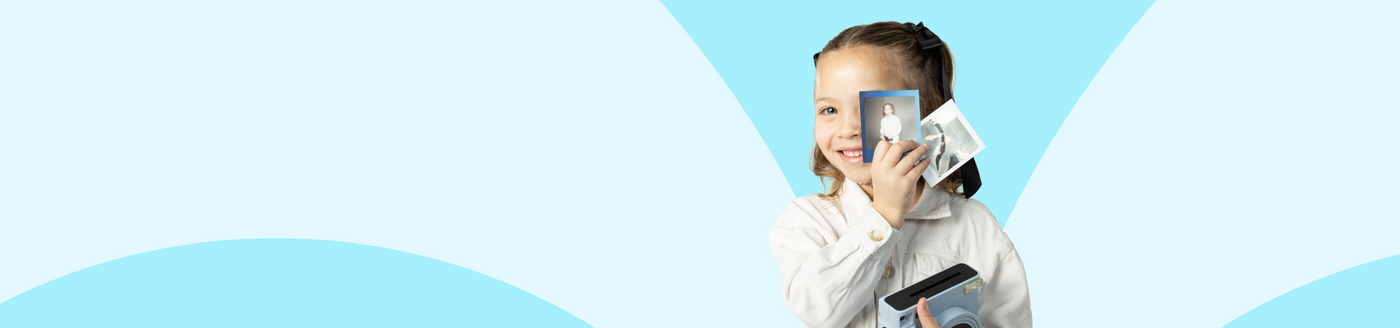 Child holding a smartphone with a blue geometric background