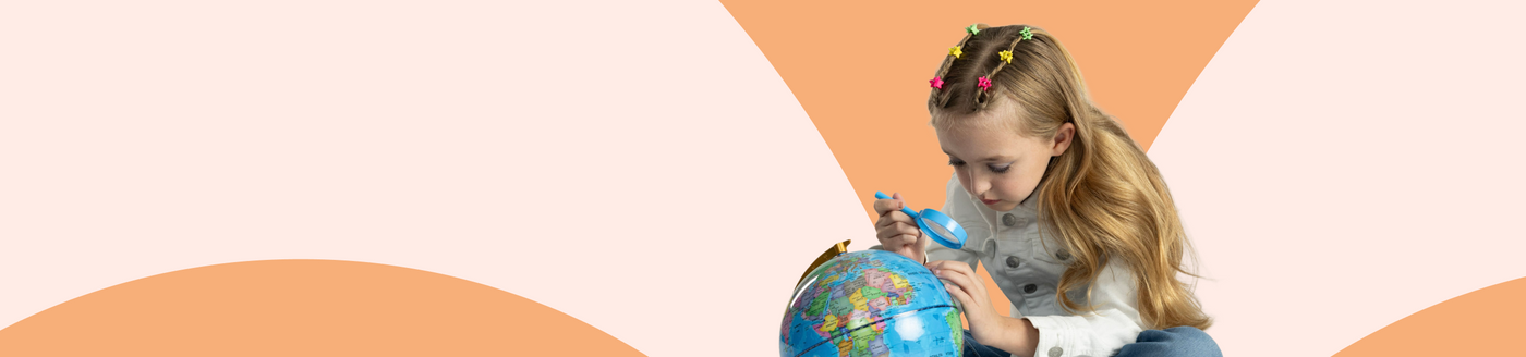 Child playing with a globe against a colorful background