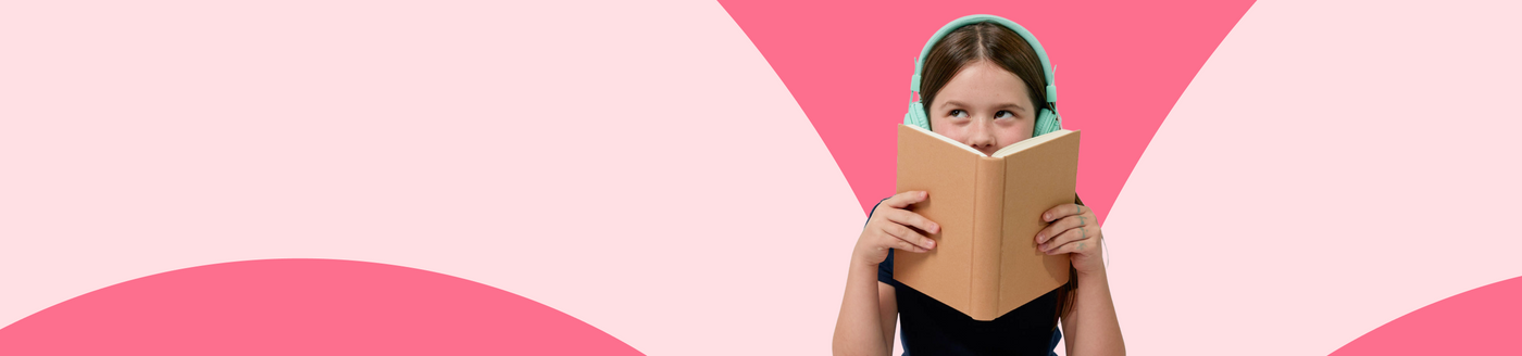 Person holding a book against a pink geometric background