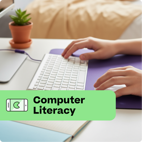 Person using a computer with a 'Computer Literacy' label on a desk.