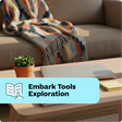 Living room with a couch, coffee table, and decorative elements, featuring 'Embark Tools Exploration' text.