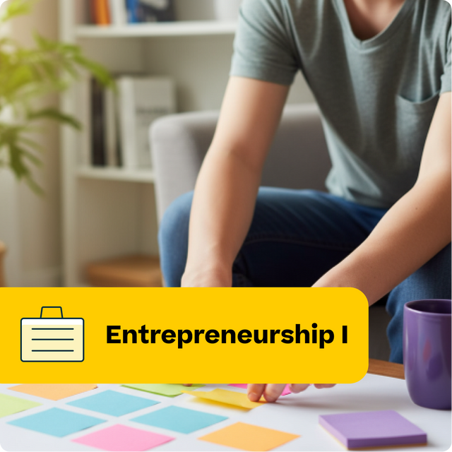 Person sitting at a table with colorful sticky notes, engaged in an entrepreneurship activity.